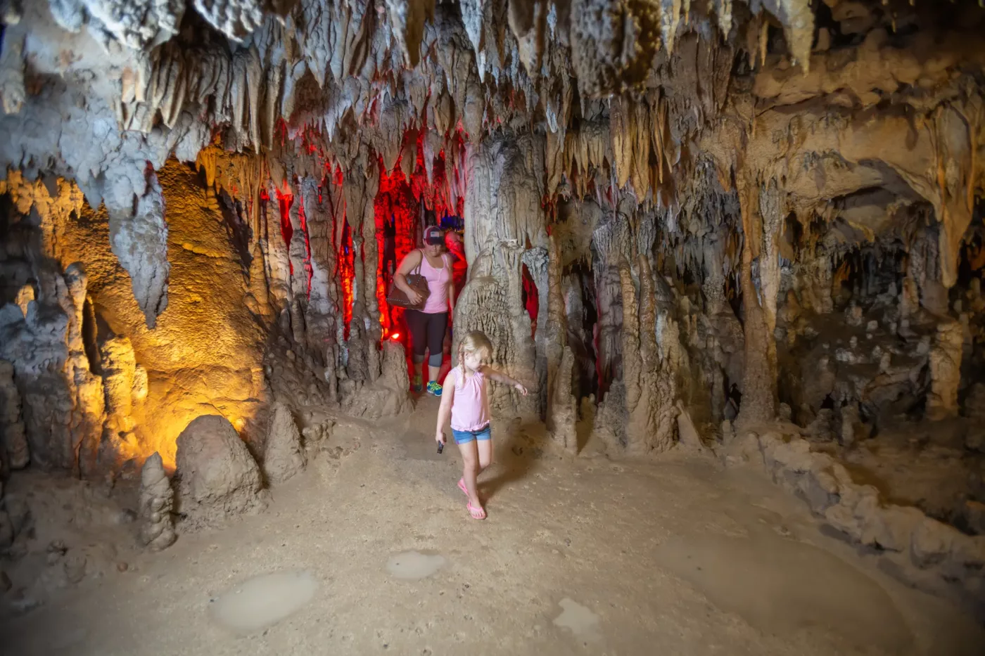 Image of a mother and daughter walking through a cavern.