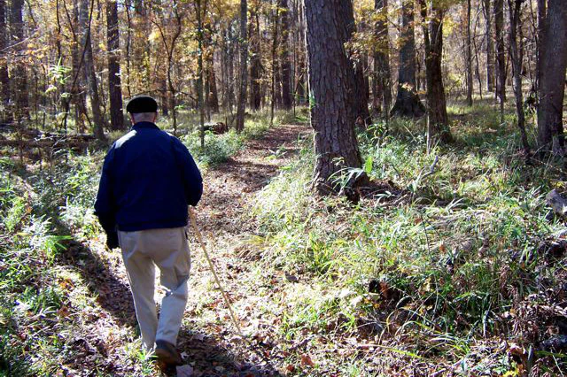 Image of a man hiking a trail at Angus Gholston.